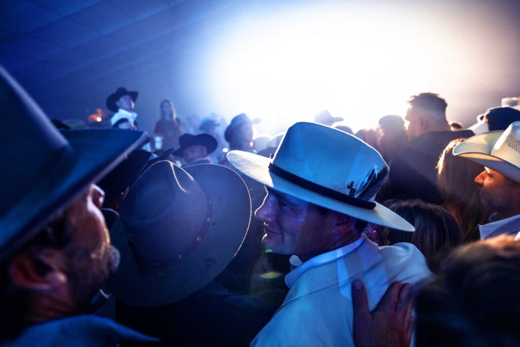 Cowboy hats fill the blue-lit concert crowd at Cattle Baron’s Ball.
