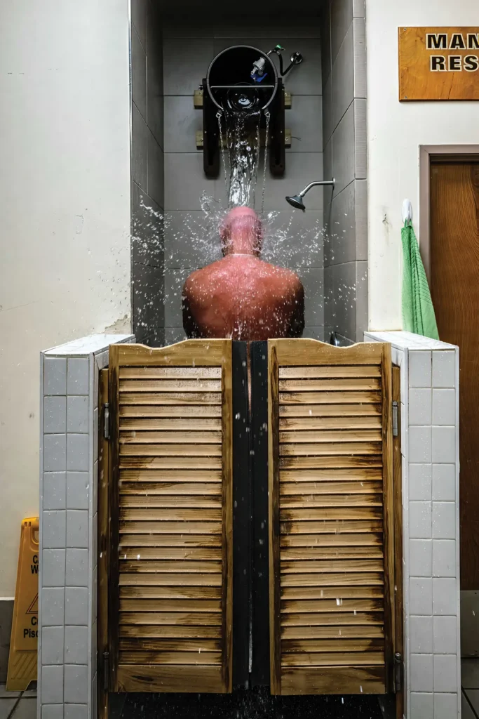A man showers behind saloon doors.