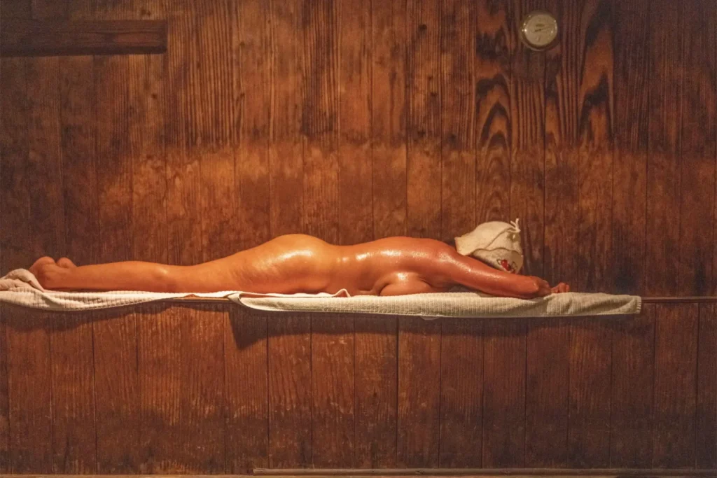 A woman lies face down in the sauna at the Russian Banya of Dallas.