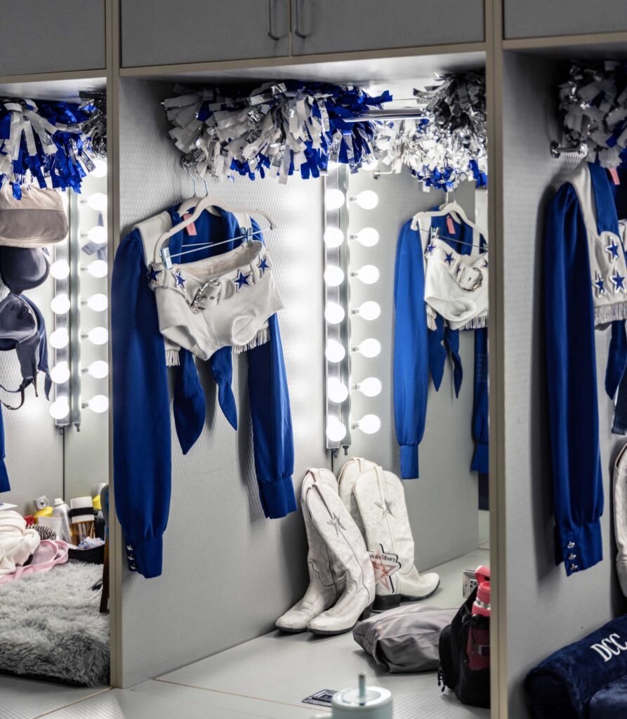 Uniforms, boots, and pom-poms wait in the lockers.