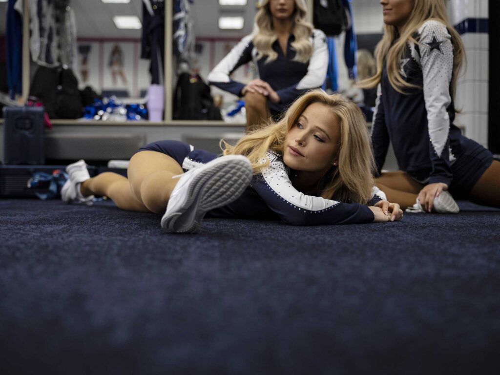 Stretching on the locker-room floor.