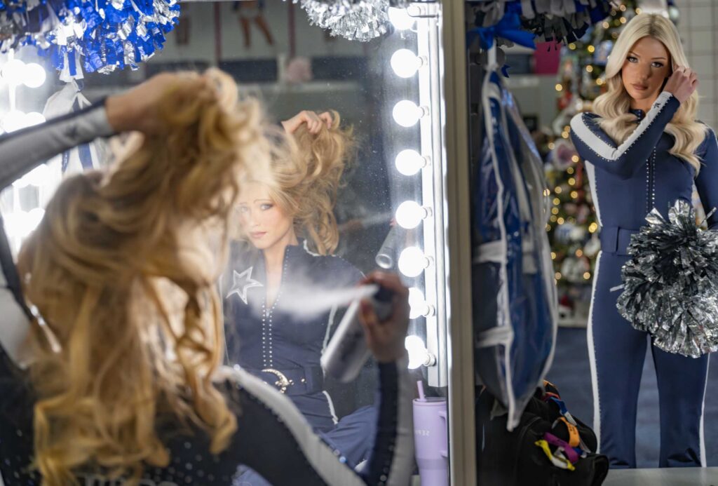 Hair and uniforms are readied under the mirror lights.